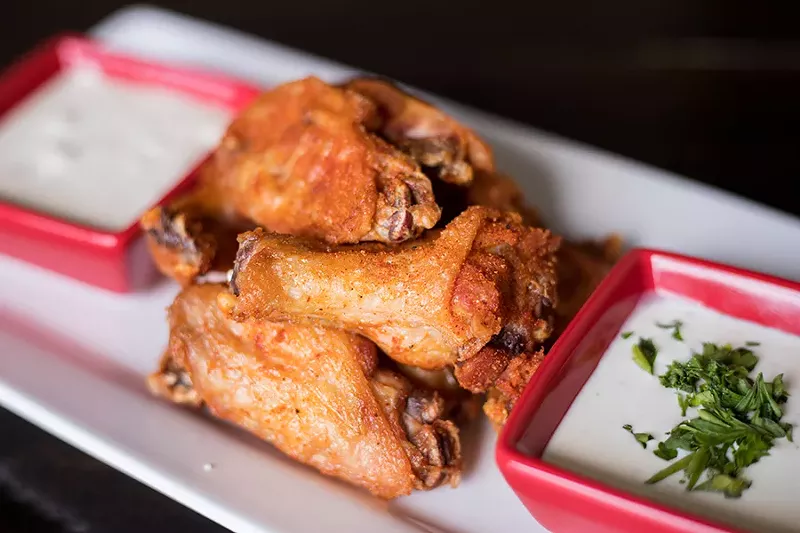 Wings are tossed in Red Hot Riplet spice and served with ranch or bleu cheese for dipping. - MABEL SUEN