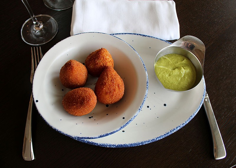 The coxinha, fried balls of chicken and Brazilian cream cheese, served with aji amarillo sauce. Craft referred to these as chicken nuggets as a child. - LEXIE MILLER
