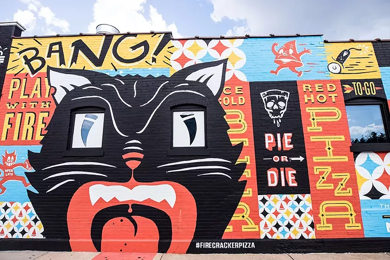 A large mural decorates one exterior wall. - MABEL SUEN