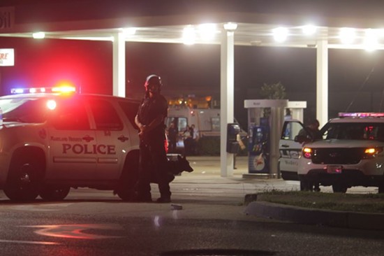 The gas station at  the intersection of Chambers Road and Florissant Avenue served as a major staging area for police on Sunday night. - DANNY WICENTOWSKI