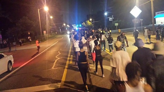 Protesters move south on West Florissant Road. They have to keep moving or risk arrest. - DANNY WICENTOWSKI