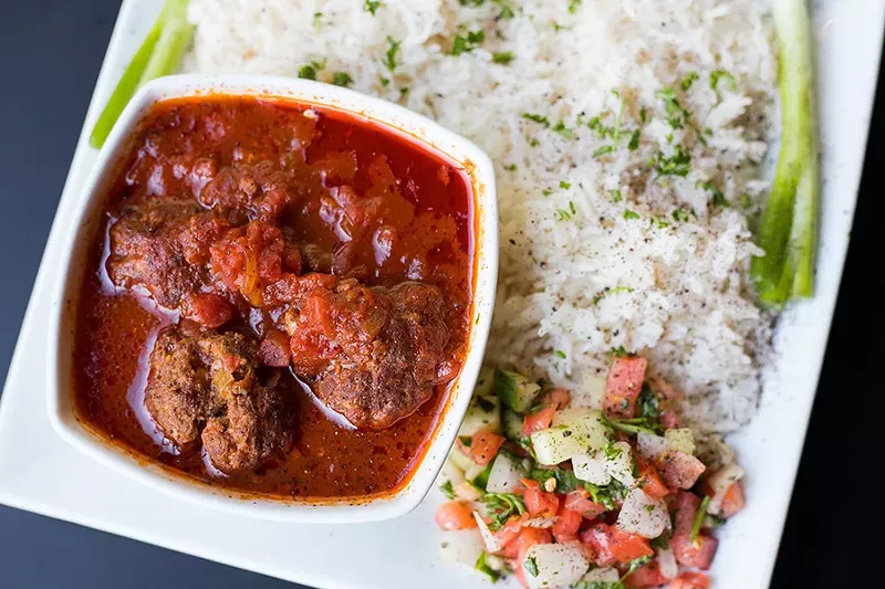Dawood basha, or meatballs cooked in tomato sauce with onions and garlic, are served with rice and salad. - MABEL SUEN