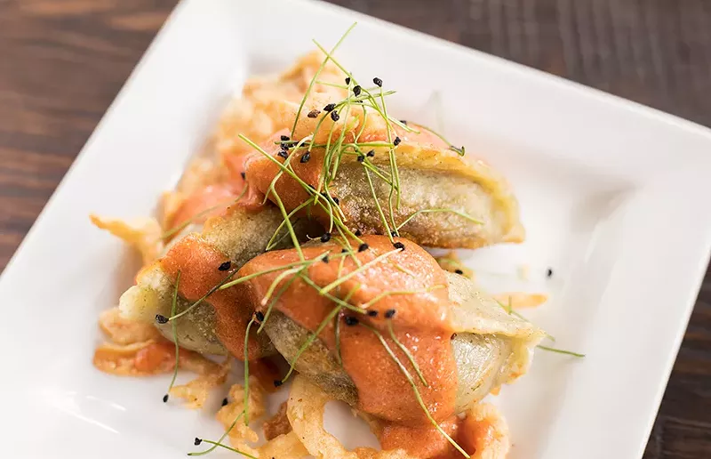 The "Quiche au Chevre breakfast" potstickers combine goat cheese and egg filling, crispy onion and tomato hollandaise. - MABEL SUEN