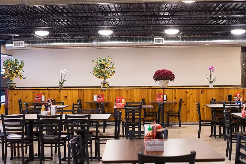 The dining room is vast, with nothing to divide the space. - MABEL SUEN