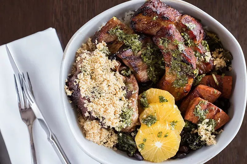 Feijoada, a traditional Brazilian dish, brims with beans, rice, oranges and various cuts of beef and pork. - MABEL SUEN