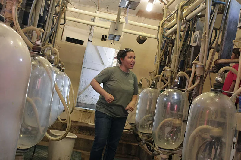 Beth Marcoot explains the automated milking process to a tour group. - PHOTO BY ALLISON BABKA