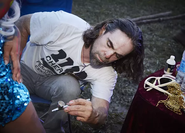 Davide Weaver at work on his installation. - PHOTO BY STEVE TRUESDELL