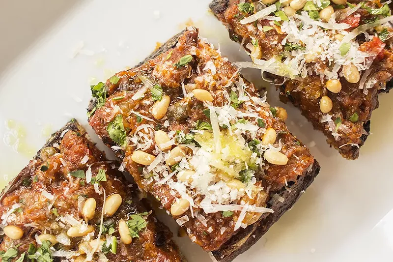 Bruschetta di caponata with roasted eggplant, raisins, olives, capers and pine nuts on toasted sourdough. - PHOTO BY MABEL SUEN