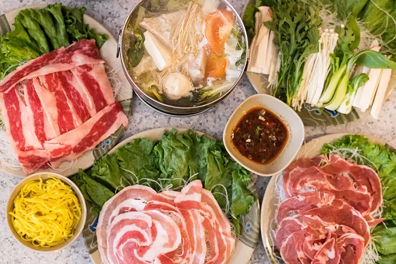 Taiwanese hot pots come with tomato, taro, mushrooms, tofu and cabbage, served with your choice of meat, noodles and dipping sauce. - MABEL SUEN