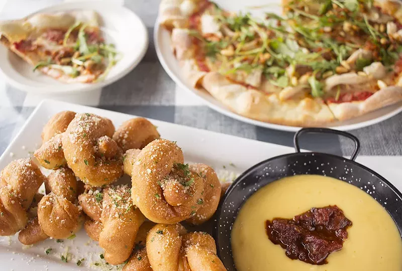 Garlic knots are served with a crock of velvety provolone fondue - PHOTO BY MABEL SUEN
