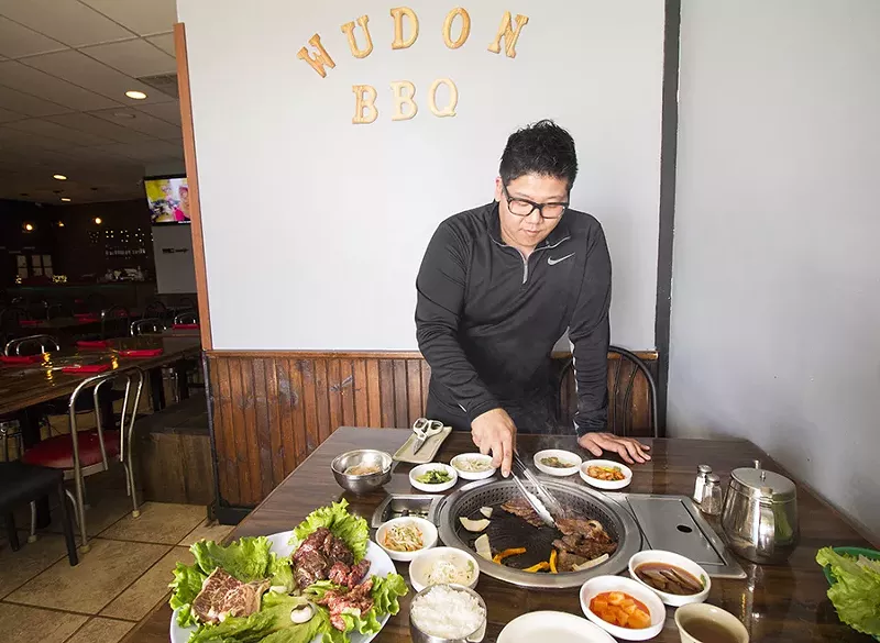 Co-owner Victor Jang shows off some tabletop grilling action. - PHOTO BY MABEL SUEN