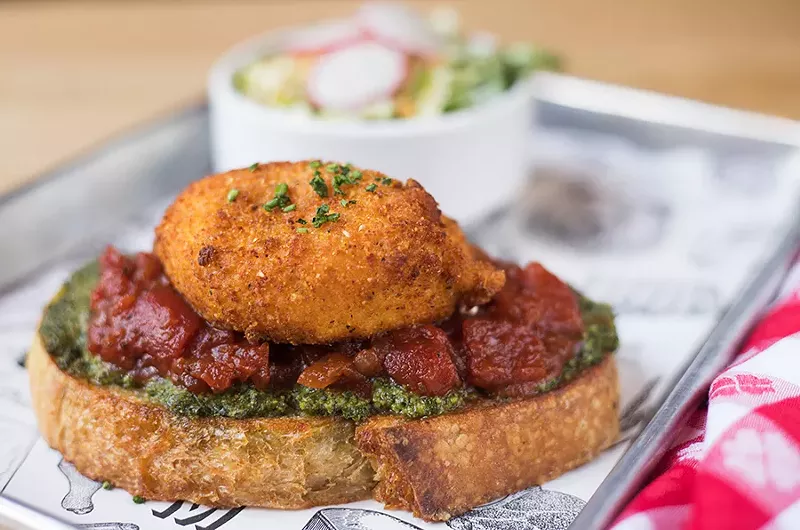 Fried burrata toast with tomato jam and herb pesto, served with a petite gem salad. - MABEL SUEN