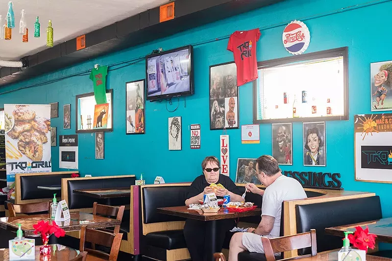 The dining area at TKO Grill features artwork of celebrities and famous boxers. - MABEL SUEN