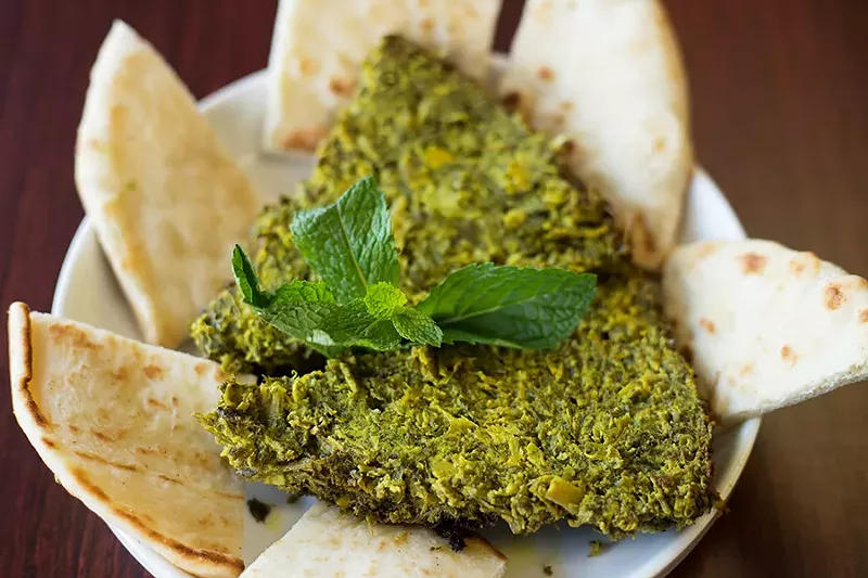 The kookoo sabzi — basically, an herb frittata — is a stunningly rich and verdant concoction. - MABEL SUEN