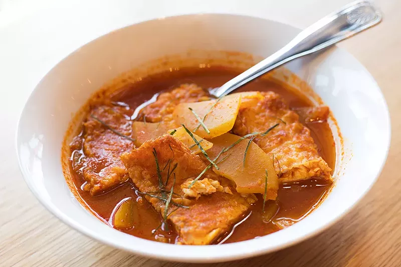 The gaeng som is a fragrant bowl of fried whitefish and papaya simmered in a turmeric and chile broth. - MABEL SUEN