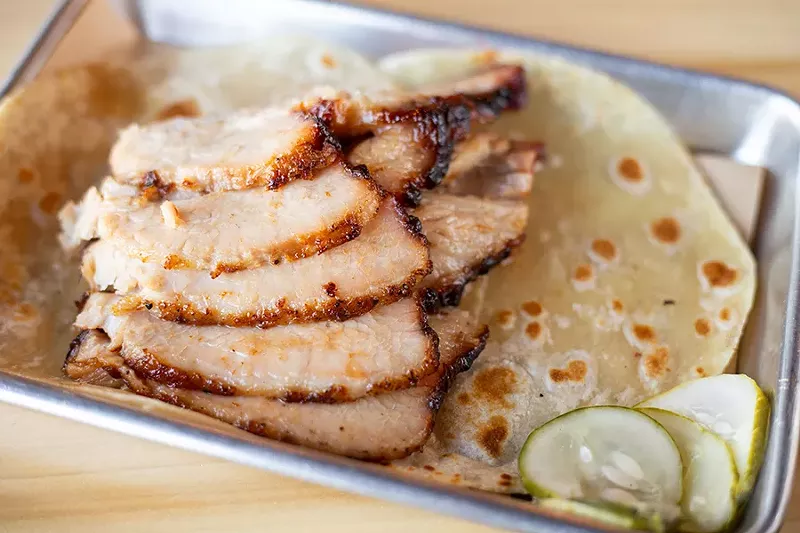One of nine platters served at BEAST Butcher & Block, the basted belly is served with either fresh tortillas or a bun. - MABEL SUEN