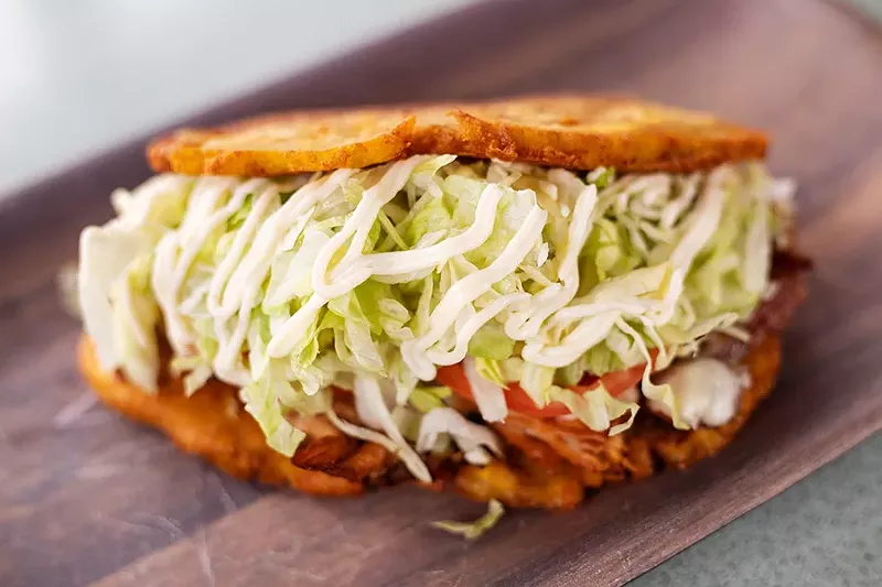 Jibarito with your choice of steak or pork, Swiss-American cheese, lettuce, tomatoes and garlic mayo served on twice-fried green plantains. - MABEL SUEN