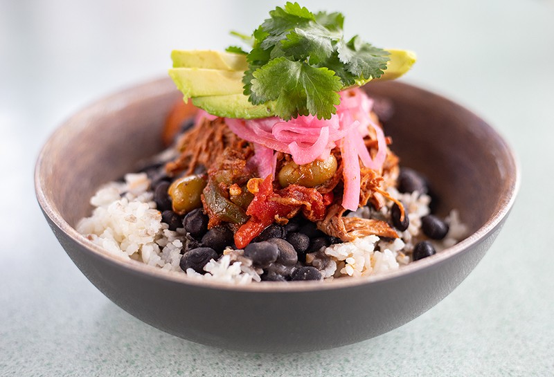 Ropa vieja with shredded slow-braised flank steak, black beans, white rice, pickled onion, maduros and avocado. - MABEL SUEN