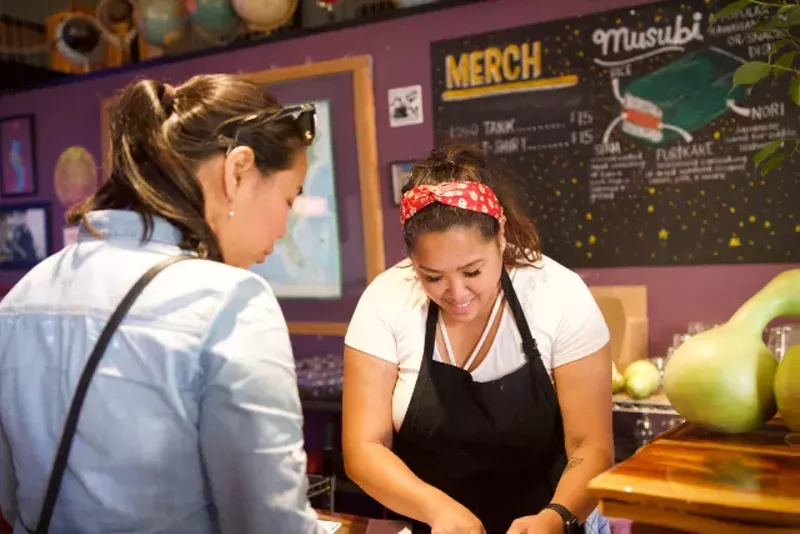 Charlene Lopez-Young behind the Fattened Caf counter at Earthbound. - COURTESY DARREN YOUNG AND CHARLENE LOPEZ-YOUNG