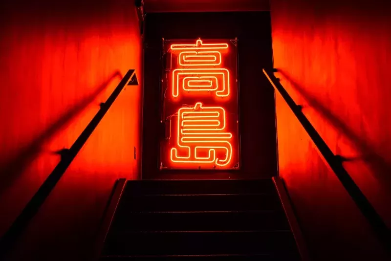 Guests are greeted to the second floor lounge area with a striking neon light. - TRENTON ALMGREN-DAVIS