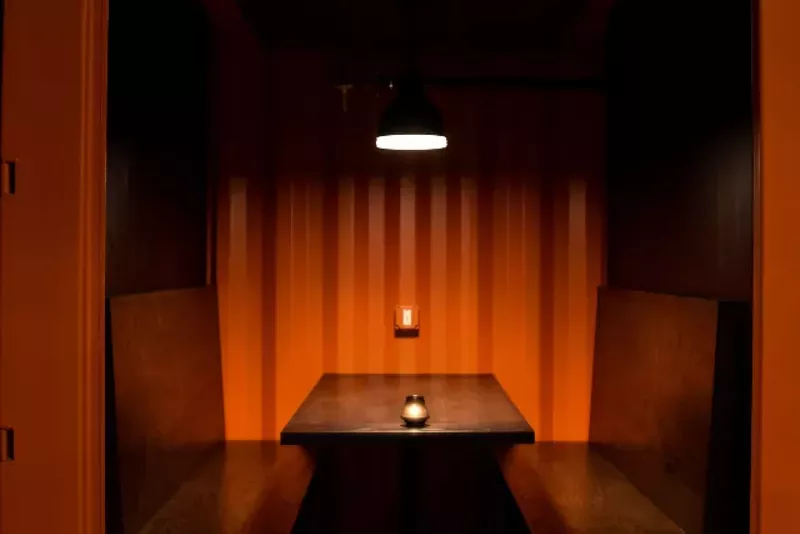 A close-up of one of the six shipping container booths on the ground floor. - TRENTON ALMGREN-DAVIS