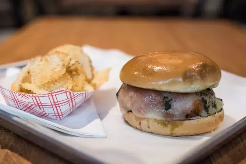 Andrew's smashed burger is larger and thicker than the traditional thin, frilly-edged patties often associated with the style. - TRENTON ALMGREN-DAVIS