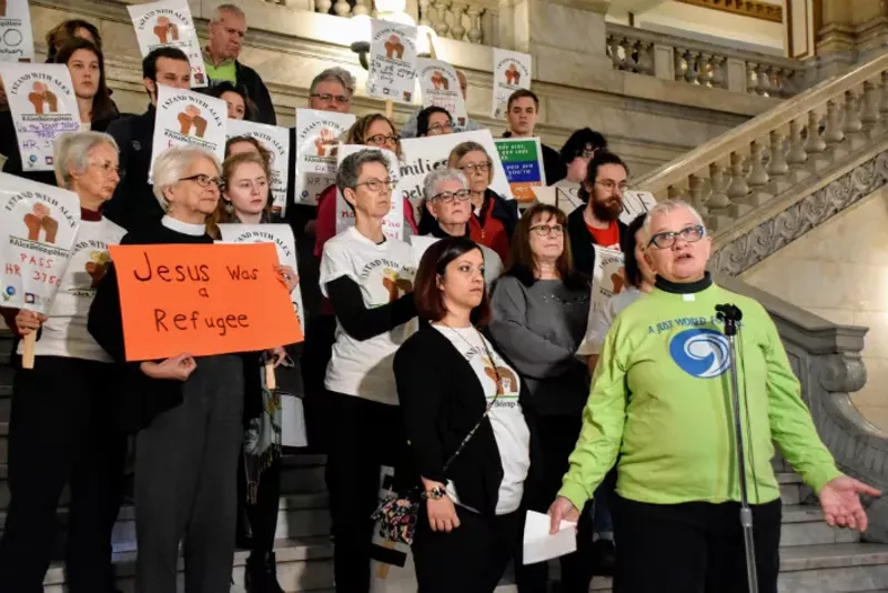 The Rev. Rebecca Turner (right) and Carly Garcia with supporters at City Hall. - DOYLE MURPHY