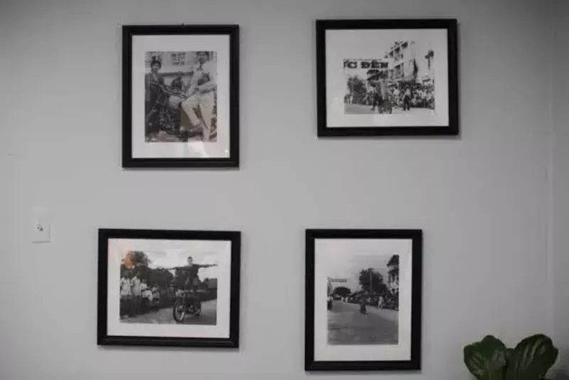 Photos of Trinh's dad performing motorcycle stunts from his time in the circus hang on the wall. - TRENTON ALMGREN-DAVIS