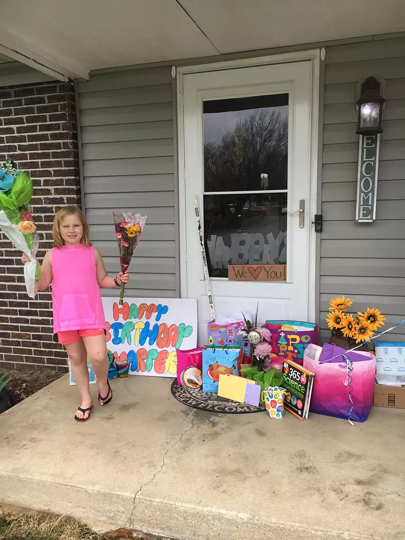 Harper poses with her presents people dropped off during the parade. - COURTESY JULIE CAMP