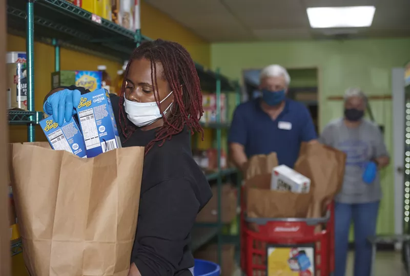 Kay Thompson, a student volunteer from Fontbonne University, fills a grocery order for a client of Feed My People in Lemay. - MARY BUTKUS