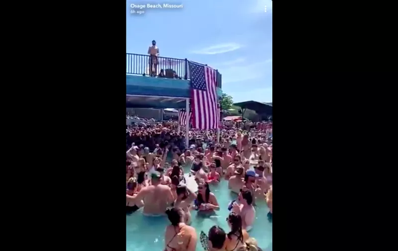 St. Louis County issued a travel advisory after videos (screengrab posted above) showed crowds of people partying at Lake of the Ozarks bars. - SCREENGRAB VIA TWITTER