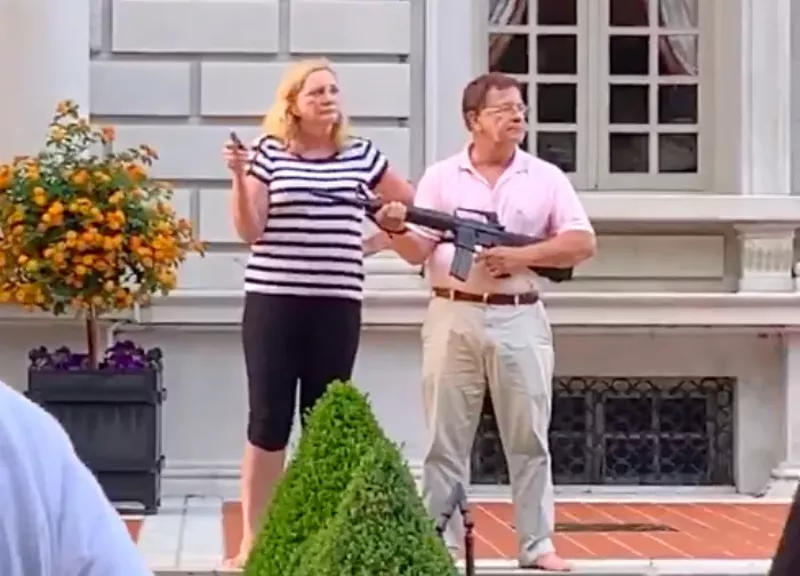 Patricia and Mark McCloskey greet marchers with guns outside their Central West End home. - SCREENGRAB OF VIDEO BY THEO WELLING