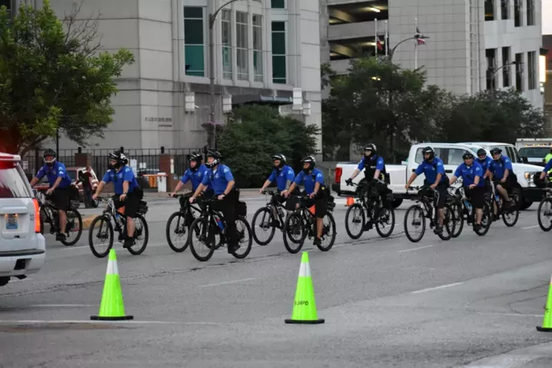 Bicycle police pedal away from City Hall. - DOYLE MURPHY