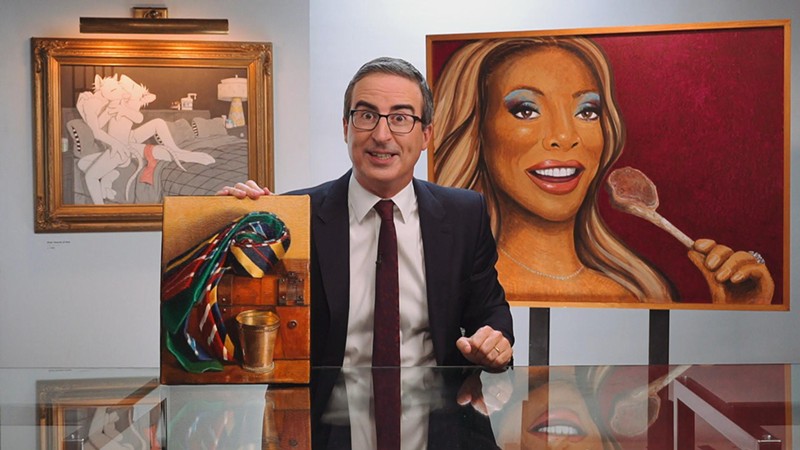 John Oliver poses with his exceptionally weird art collection at the close of Sunday's show. - SCREENSHOT VIA LAST WEEK TONIGHT