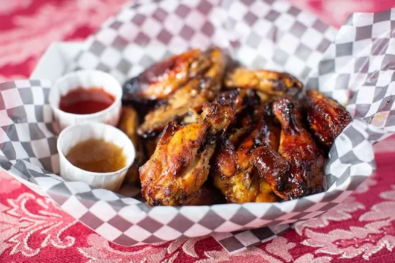 Honey lemon pepper wings served with an assortment of housemade hot sauces such as peach habanero and cranberry red. - MABEL SUEN