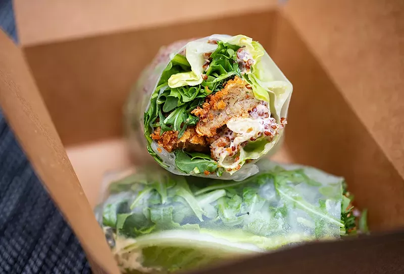 Basil crab cake served in a rice paper wrap with baby arugula, garlic-basil aioli and Sriracha. - MABEL SUEN