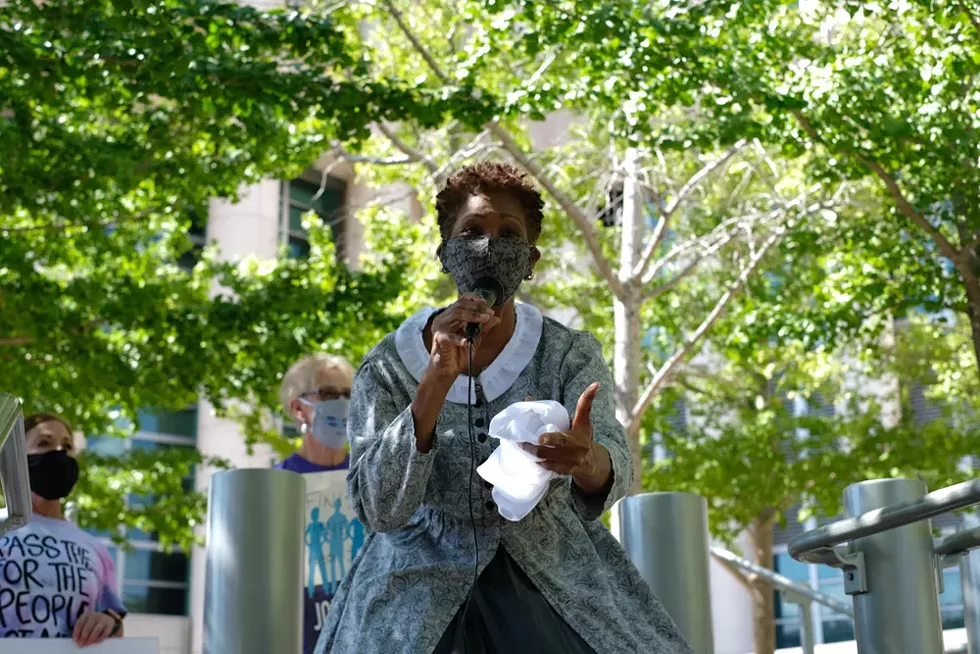 Outside the Thomas F. Eagleton U.S. Courthouse, Peggy Neely-Harris performs a scene based on the Dred Scott case as Denise Lieberman (far left) watches. - PHUONG BUI