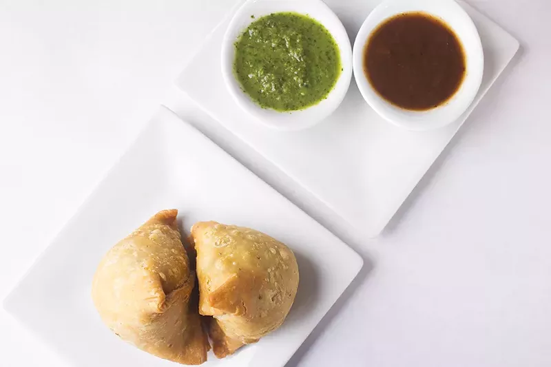 Samosas are filled with mildly spiced potatoes, peas, chick peas and dried fruits. - MABEL SUEN