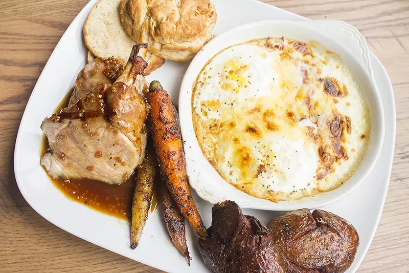 The presentation of the pork chop is a bit odd: A crock of shirred eggs and bacon makes for a strange side dish. - PHOTO BY MABEL SUEN
