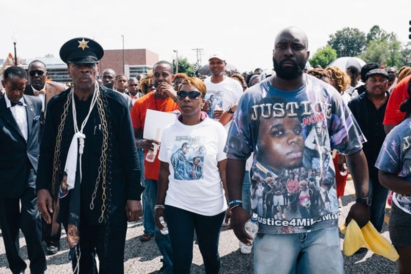 Lezley McSpadden, center, Michael Brown's mother, and Michael Brown Sr., right. - PHOTO BY BRYAN SUTTER