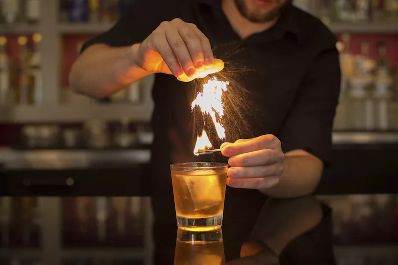 A bartender at the Gin Room works his magic. - MONICA MILEUR
