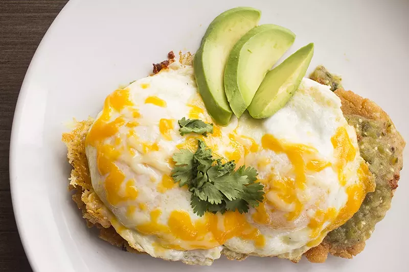 Arepas consist of a grilled corn cake with chorizo, over-easy eggs, avocado, cheddar and chile verde. - PHOTO BY MABEL SUEN