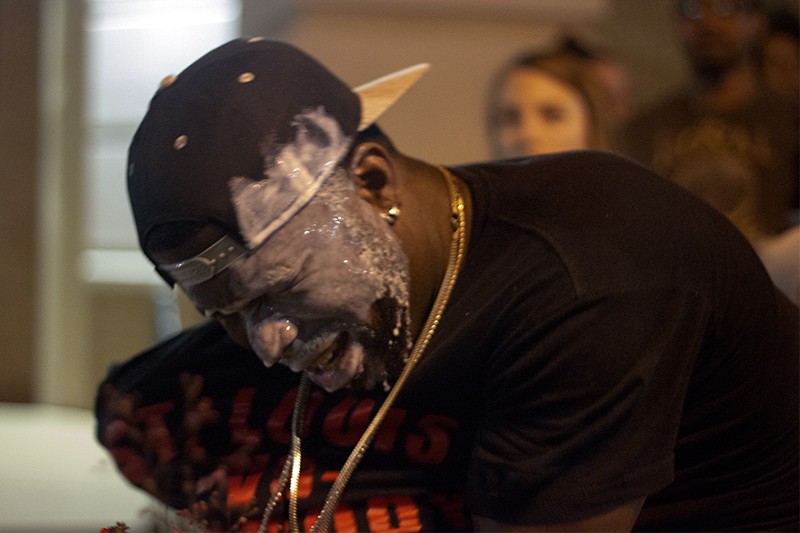 Bystanders treated a man affected by police pepper-spraying by pouring milk on his face. - PHOTO BY DANNY WICENTOWSKI