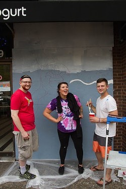 Artists Mark Ostroot, Nicole High and Layden Walley work on the plywood covering Fro Yo. - COURTESY OF PAINTING FOR PEACE IN FERGUSON, A CHILDREN'S BOOK