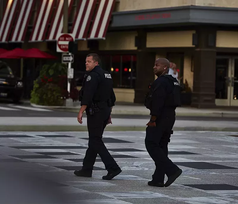 Rossomanno and Sgt. Randy Jemerson (right) have a good cop, bad cop reputation among protesters. - THEO WELLING