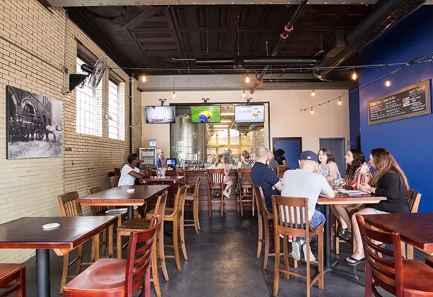 Beyond large doors that open garage-style is a tap room perfect for summer drinking. - MABEL SUEN