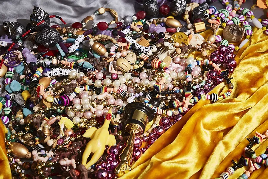 Auntie M's beads come from all over the world. Many are purchased, but some are acquired by barter. "I had to sweeten the deal a bit to make that trade," Auntie M says of his prized rubber chicken beads. - THEO WELLING