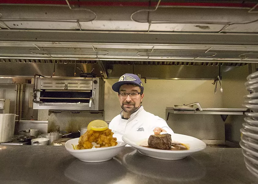 Executive chef Tyler Layton with the batter-dipped lobster tail and filet mignon. - PHOTO BY MABEL SUEN