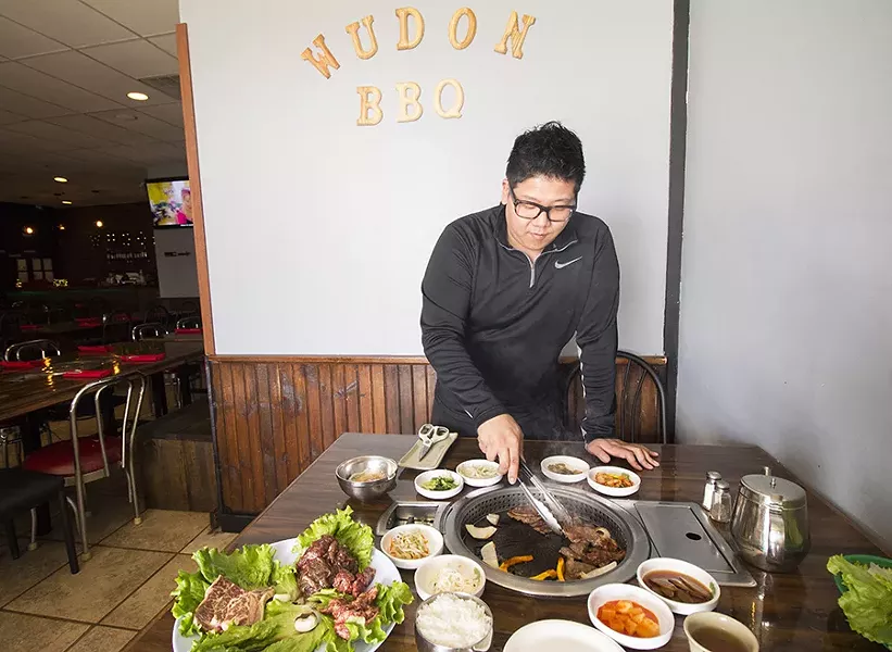 Co-owner Victor Jang shows off some tabletop grilling action. - PHOTO BY MABEL SUEN