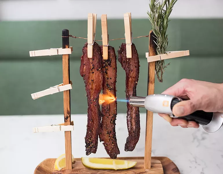 The chef’s signature “Clothesline Bacon” is served with a pickle. - MABEL SUEN